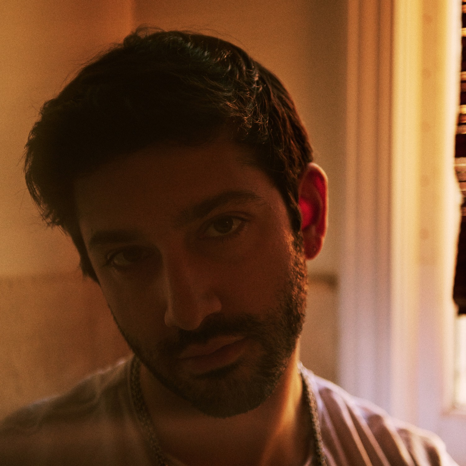 Close portrait of Sam Haiman in warm lamplight